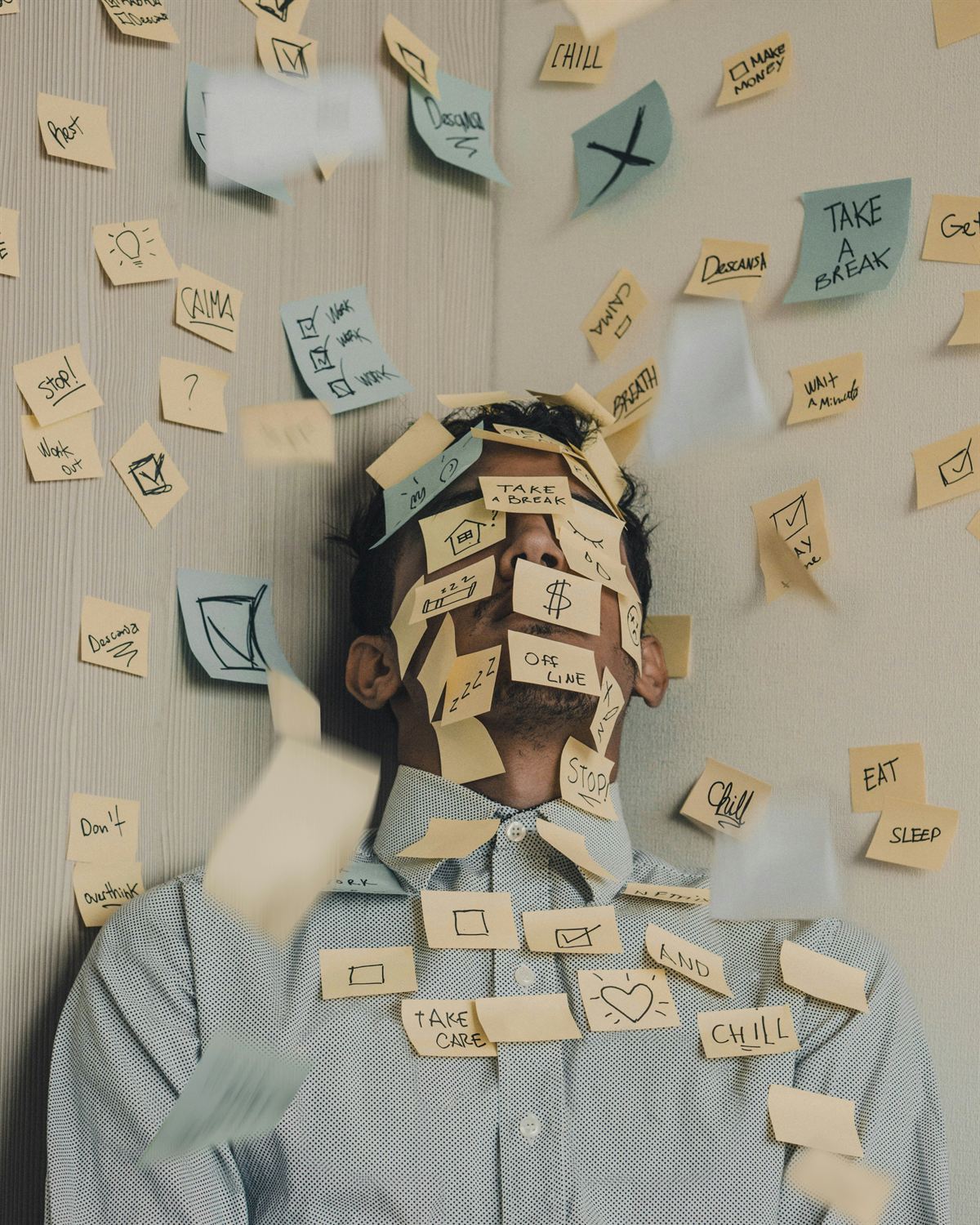 Overloaded employee covered in sticky notes